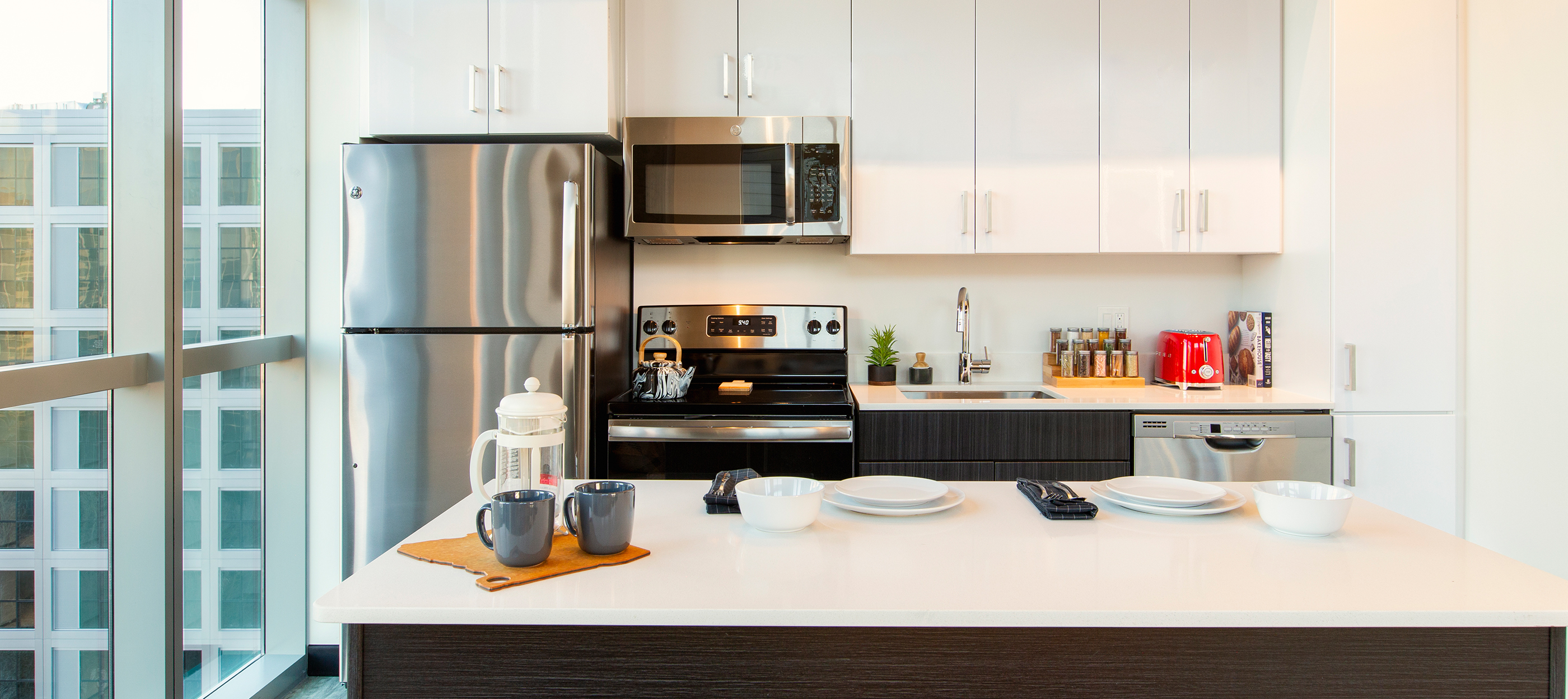 A kitchen with modern appliances and white cabinets