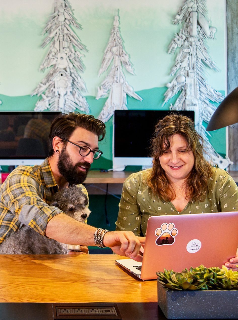 Two people looking at a laptop